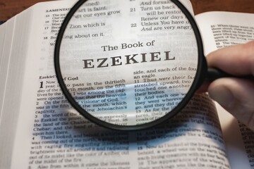 title page book of Ezekiel close up using magnifying glass in the bible or Torah for faith, christian, hebrew, israelite, history, religion, christianity, Old Testament