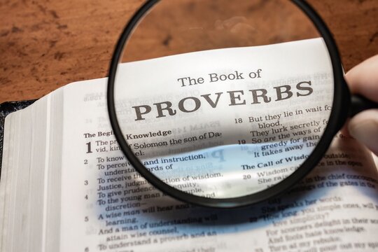 title page book of Proverbs close up using magnifying glass in the bible or Torah for faith, christian, hebrew, israelite, history, religion, christianity, Old Testament