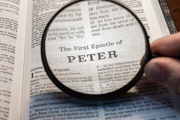 title page book of first peter close up using magnifying glass in the bible for faith, christian,...
