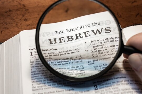 title page book of Hebrews close up using magnifying glass in the bible for faith, christian, hebrew, israelite, history, religion, christianity, new testament