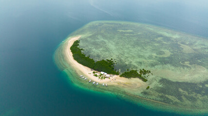 Top view of tropical island and a sandy beach in the sea. Honda Bay. Palawan, Philippines.