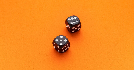 Dice for board game on orange background - Entertainment in casino