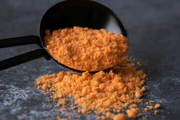 Cheddar Cheese Powder Spilled from a Teaspoon