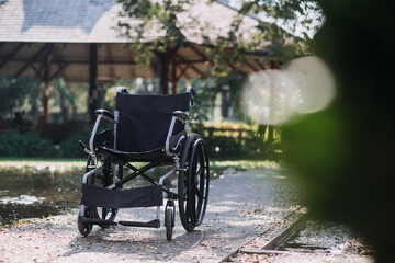 Asian young caregiver nurse support senior older male walking outdoors. Specialist girl doctor help and take care of elderly mature man patient doing physical therapy in public park at nursing home.