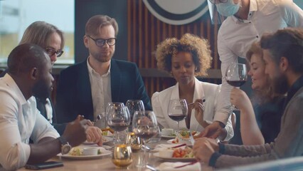 Waiter bring order to woman in restaurant. Realtime