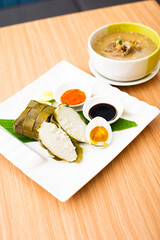 A Traditional Makassar dish, called Coto Makassar served with packed rice and a side of salted egg