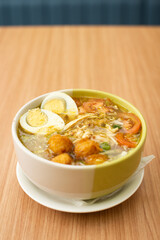 A Plate of Soto Ayam served with rice and condiments