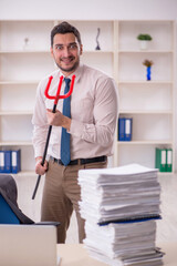 Young male employee unhappy with excessive work in the office