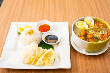 A Plate of Soto Ayam served with rice and condiments