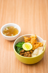 An bowl of chicken noodles served with potstickers