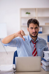 Naklejka premium Young male employee working in the office
