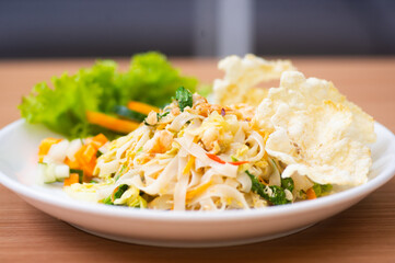 A Plate of vegetable salad served with indonesian crisps