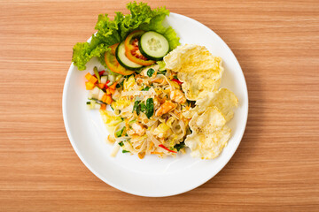 A Plate of vegetable salad served with indonesian crisps