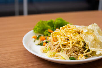 Indonesian Fried Noodles topped with shredded egg on top