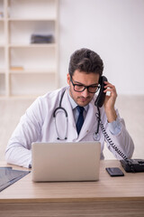 Young male doctor in telemedicine concept