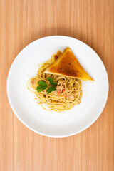 A Plate of spaghetti aglio olio with tuna and grilled bread