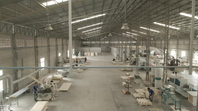 Drone view of a forklift is driving in the factory. and each worker is working on the machine on January 18, 2023 in Phanom Sarakham, Chachoengsao, Thailand