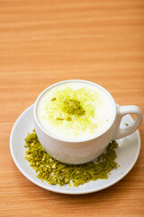 A Glass of matcha drink, served with crumble of matcha chocolate
