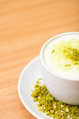 A Glass of matcha drink, served with crumble of matcha chocolate