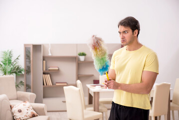 Young man doing housework indoors