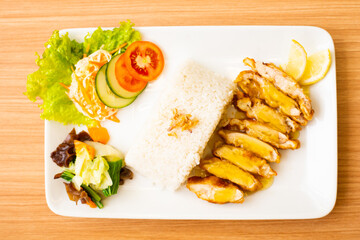 A Lemon Chicken Cutlet Dish, Servied with Rice and a side of salad