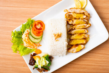 A Lemon Chicken Cutlet Dish, Servied with Rice and a side of salad