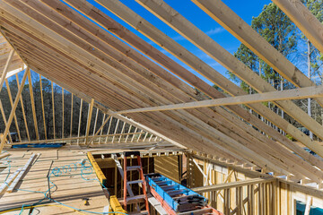 Wooden roof framework from trusses was constructed as part construction of new beam stick to home