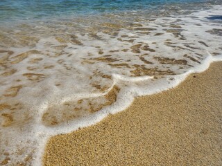 foamy waves on the sand