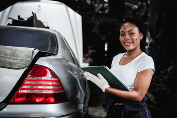 Portrait of  Car mechanic repairs and inspects the car's suspension in detail in the garage. Car...