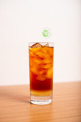 A Glass of iced tea, served with a stirrer