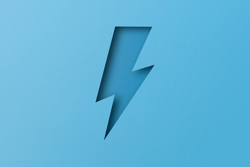 light blue paper cut into holes Lightning bolts are overlaid with light and shadow.