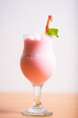 Strawberry milkshake served with a wafer straw
