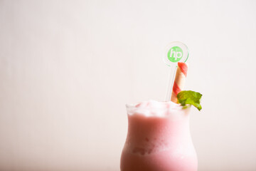 Strawberry milkshake served with a wafer straw