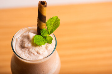 Chocolate milkshake served with a chocolate wafer straw
