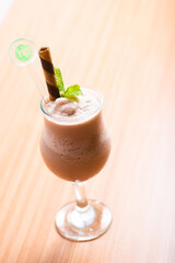 Chocolate milkshake served with a chocolate wafer straw