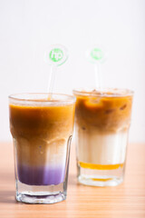 A Cup of latte served with syrup
