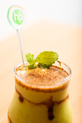 Avocado smoothie served with a mint leaf as garnish