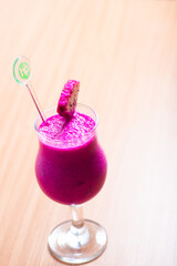 Dragonfruit smoothie served with a slice of dragonfruit