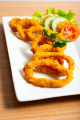 Deep fried onion rings served with tartar sauce and chili sauce