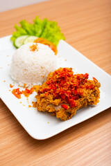 Indonesian Dish Ayam Geprek,  Deep Fried Chicken topped with spicy chili and served with white rice