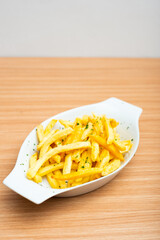 A Plate of french fries served with parsley leaf