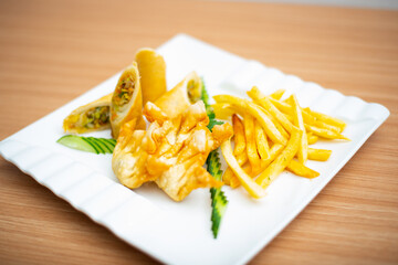 A Plate of mixed fried snacks filled with vegetables