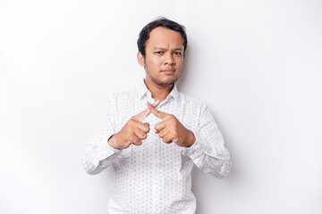 Handsome Asian man wearing white shirt with hand gesture pose rejection or prohibition with copy...