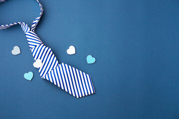 Tie with love heart on blue background, happy fathers day concept