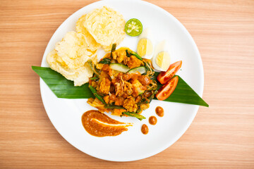 A Plate of indonesian salad, gado gado served with peanut sauce