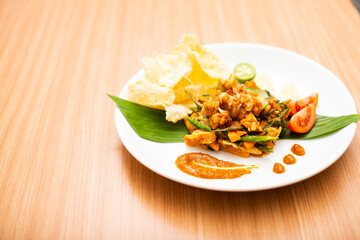 A Plate of indonesian salad, gado gado served with peanut sauce