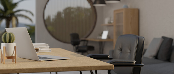 Side view of workspace with laptop and office chair in minimal and cozy office studio