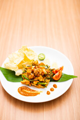 A Plate of indonesian salad, gado gado served with peanut sauce