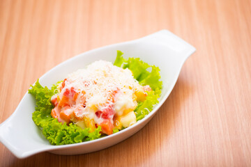 A Serving of healthy salad topped with mayonaise