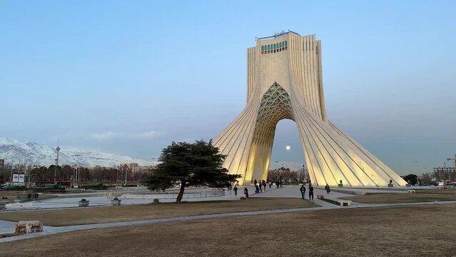 People Traveling to Iran Tehran the capital city of the country in middle east visit iconic landmark minimal landscape tourist attraction in city center downtown Azadi square Shahyad tower museum art